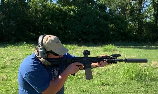 Salvo's Matt Tate shooting AR carbine with suppressor